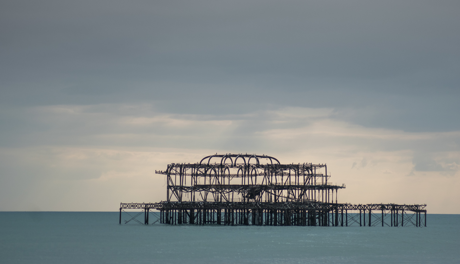 the west brighton pier on a dusk sky